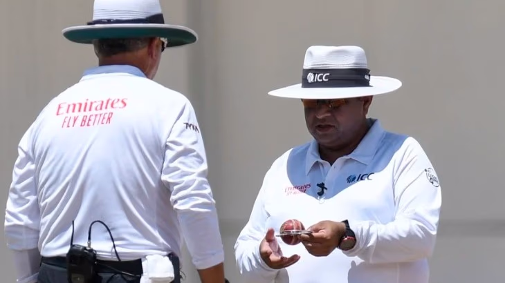 Umpire inspecting the ball.jpg